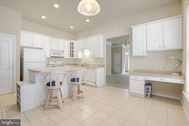 kitchen featuring light countertops, white appliances, glass insert cabinets, and white cabinetry