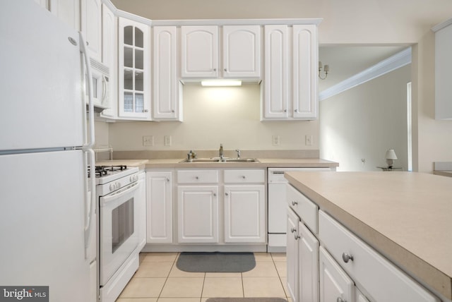 kitchen featuring glass insert cabinets, white appliances, white cabinetry, and a sink