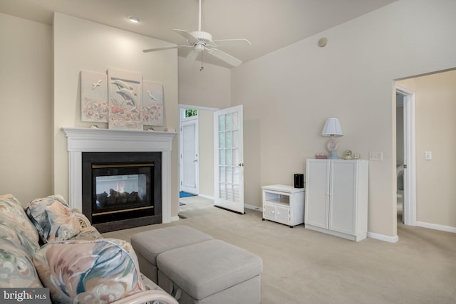 living area featuring high vaulted ceiling, light carpet, a multi sided fireplace, and baseboards