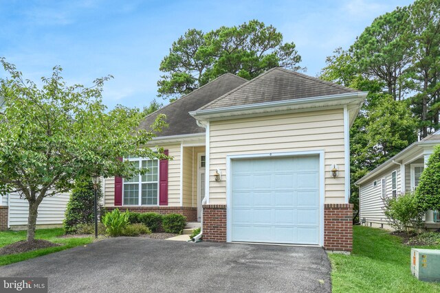 view of front of property with a garage and a front lawn