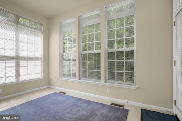 unfurnished sunroom featuring visible vents