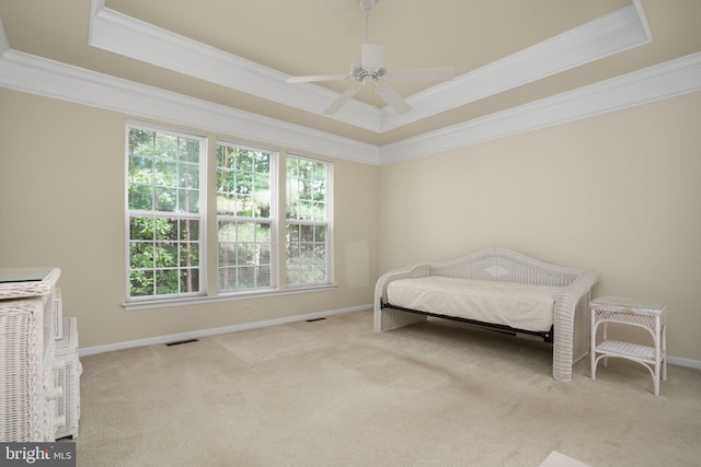 bedroom featuring a tray ceiling, multiple windows, and visible vents