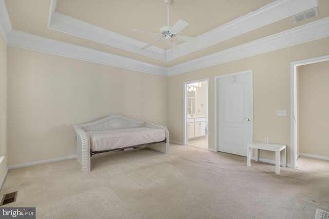 bedroom featuring visible vents, a raised ceiling, and light colored carpet