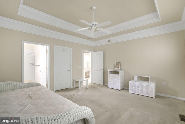 bedroom featuring light carpet, a tray ceiling, and ornamental molding