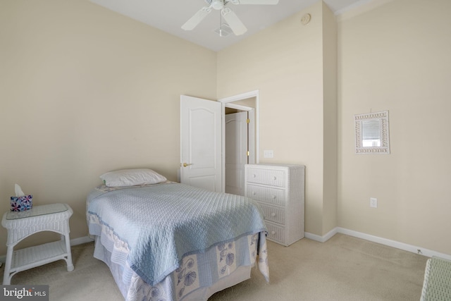 bedroom featuring light colored carpet, ceiling fan, and baseboards