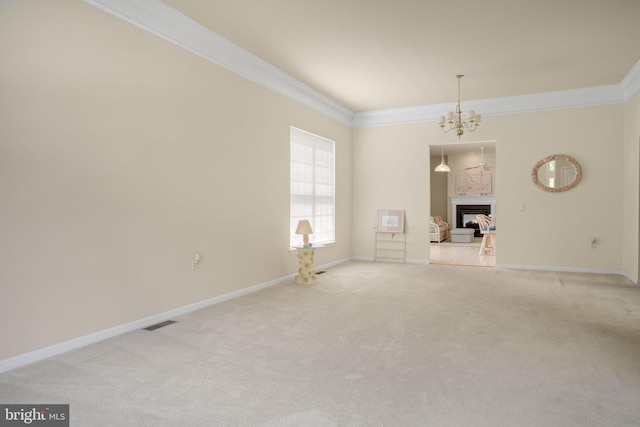 unfurnished room with ornamental molding, a fireplace, visible vents, and light colored carpet