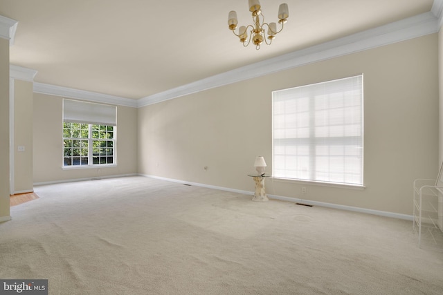 spare room featuring ornamental molding, carpet floors, and baseboards