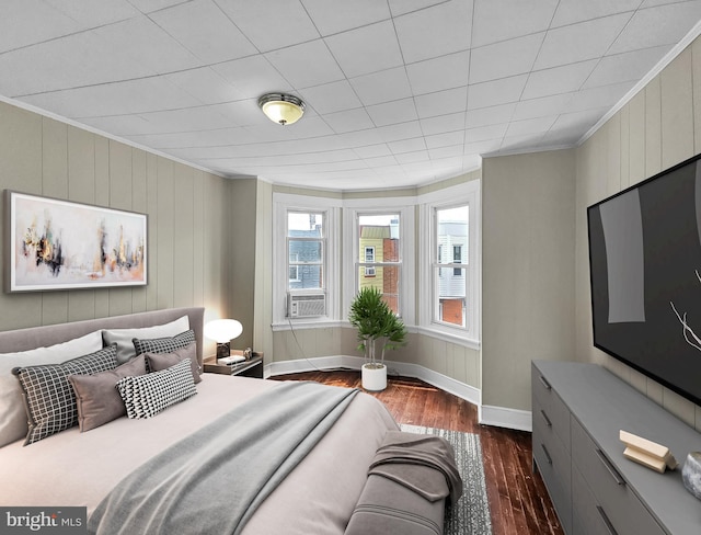 bedroom featuring cooling unit, baseboards, dark wood finished floors, and crown molding