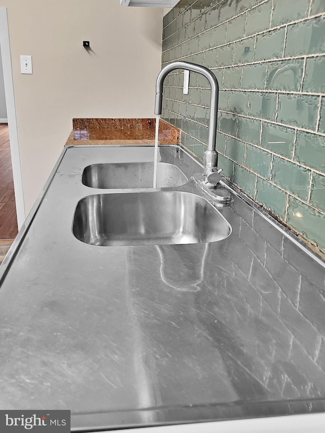 details featuring tasteful backsplash and a sink