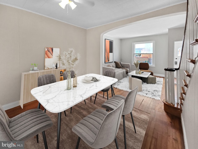 dining area with ornamental molding, ceiling fan, and hardwood / wood-style floors