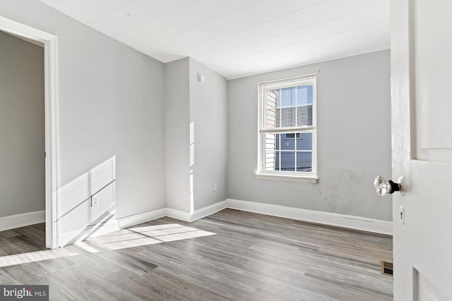 spare room with light hardwood / wood-style floors