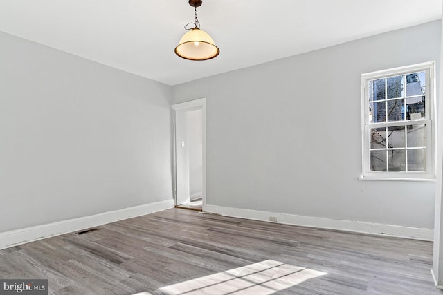 unfurnished room with light wood-type flooring