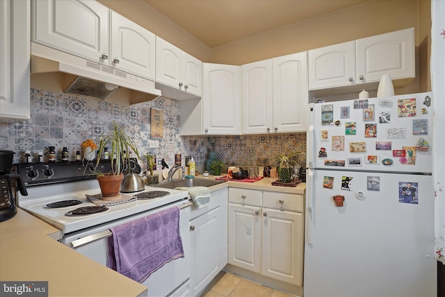 kitchen featuring white cabinets, decorative backsplash, white appliances, and light tile patterned floors