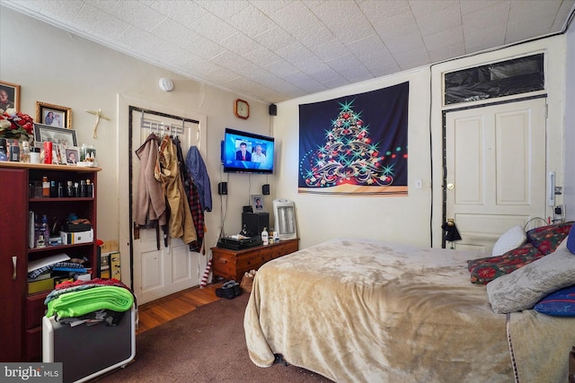 bedroom featuring dark hardwood / wood-style flooring and ornamental molding