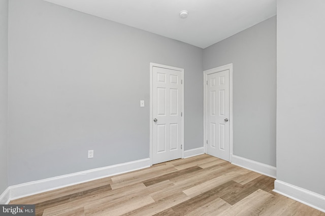 empty room with light hardwood / wood-style floors