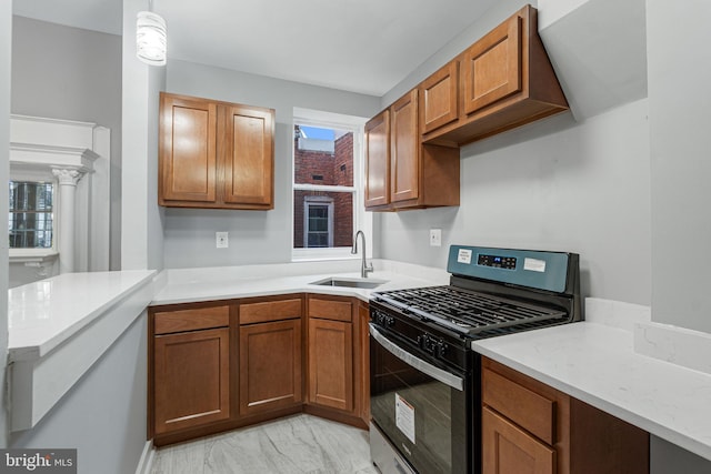 kitchen with black range with gas stovetop, hanging light fixtures, and sink