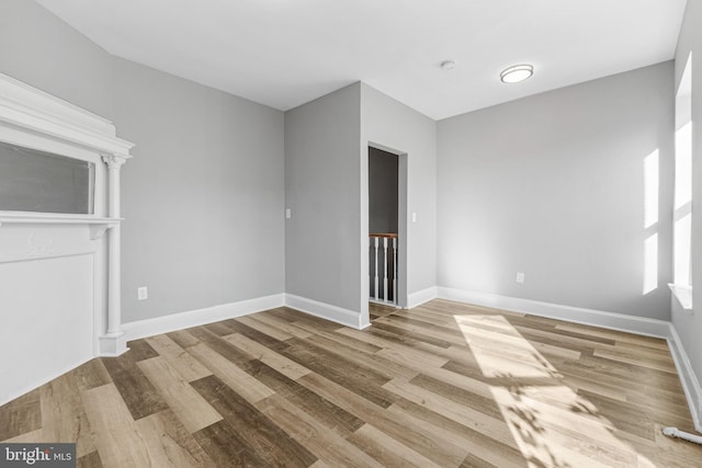 unfurnished room with hardwood / wood-style floors