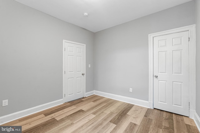 spare room featuring light hardwood / wood-style flooring