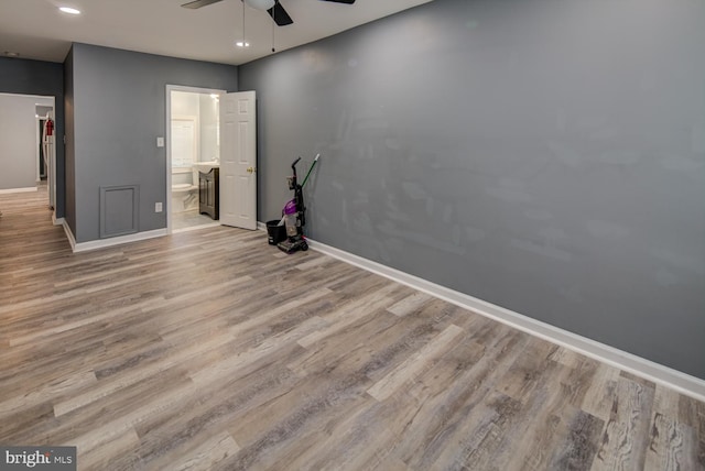 empty room with light wood-type flooring and ceiling fan