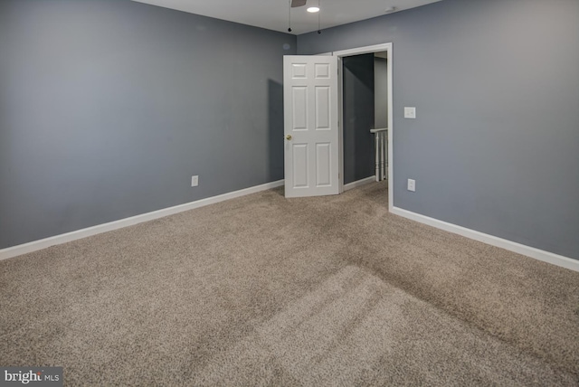 spare room featuring carpet and ceiling fan