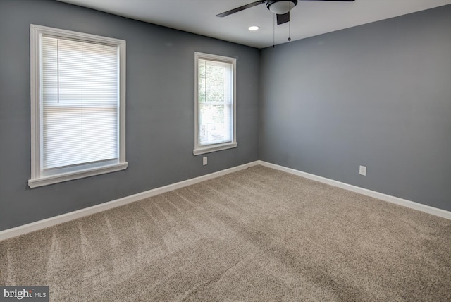 carpeted empty room featuring ceiling fan