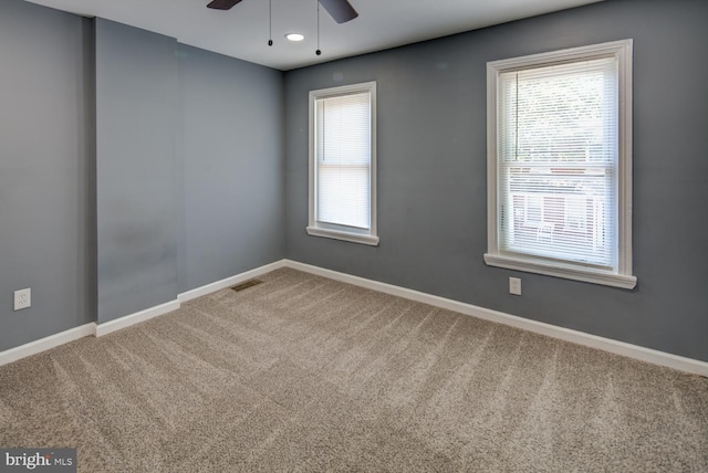 carpeted empty room featuring ceiling fan