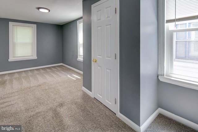 unfurnished room featuring carpet