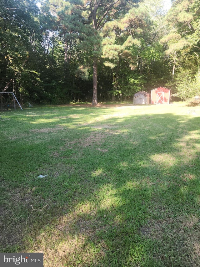 view of yard featuring a storage unit and an outbuilding