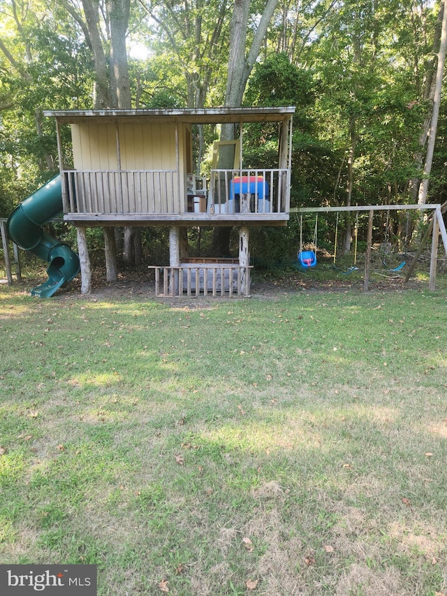 view of front facade with a front lawn and a playground