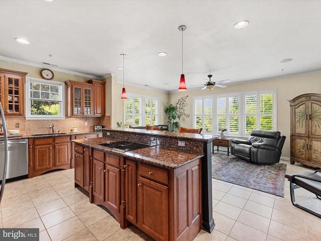 kitchen with stainless steel dishwasher, dark stone counters, cooktop, ceiling fan, and pendant lighting