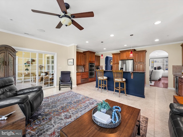 living room with ceiling fan, light tile patterned floors, and ornamental molding