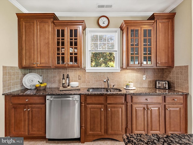 kitchen featuring sink, dark stone counters, and tasteful backsplash