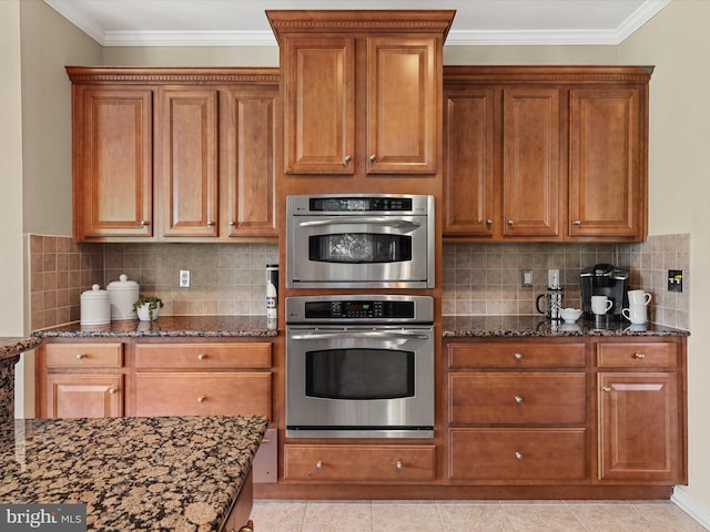 kitchen with stainless steel double oven, tasteful backsplash, crown molding, and dark stone countertops