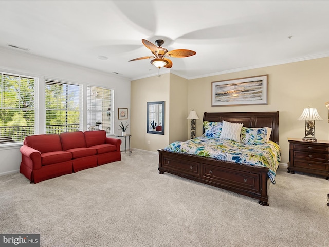 carpeted bedroom featuring ceiling fan, crown molding, and multiple windows