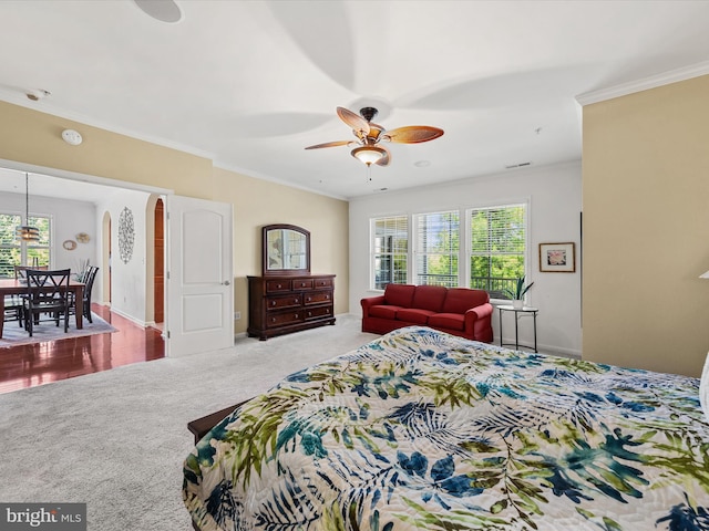 bedroom featuring carpet floors, ceiling fan, and ornamental molding