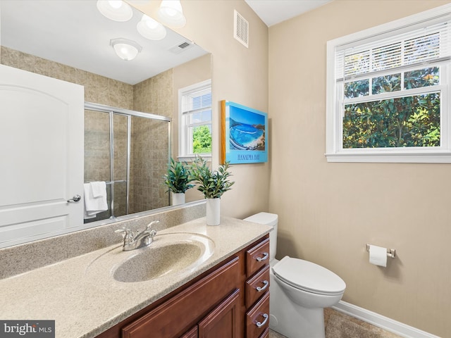 bathroom with toilet, vanity, and walk in shower