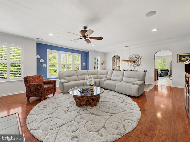 living room with ceiling fan, light hardwood / wood-style flooring, and ornamental molding