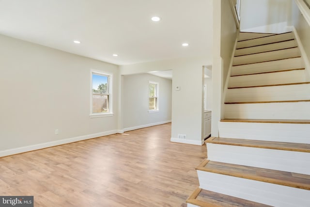 staircase with hardwood / wood-style flooring