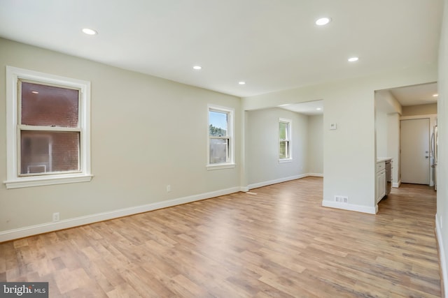 spare room featuring light wood-type flooring