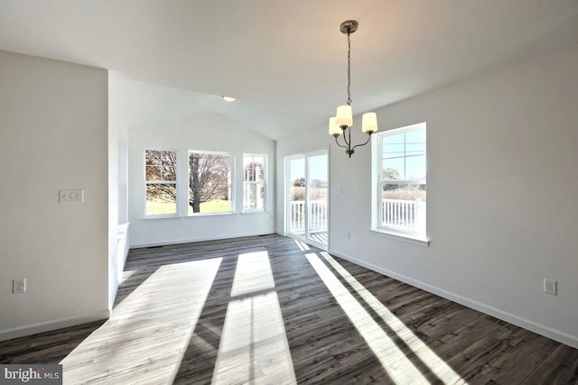 unfurnished dining area featuring vaulted ceiling, dark hardwood / wood-style floors, and a chandelier