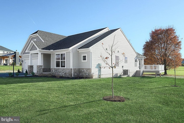 view of side of home featuring a lawn, a wooden deck, and a garage