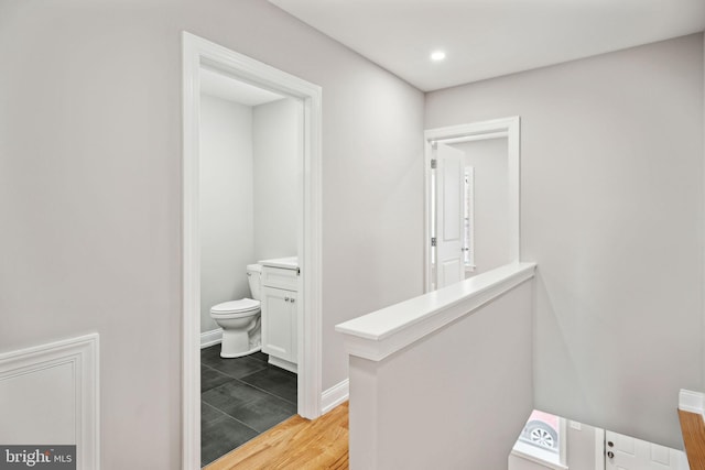 bathroom featuring wood-type flooring, vanity, and toilet