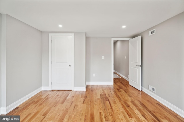 unfurnished room with light wood-type flooring