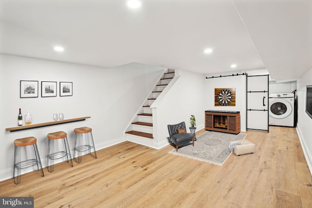 interior space with light hardwood / wood-style floors and washer / dryer