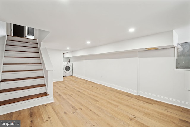 basement with light wood-type flooring and washer / clothes dryer