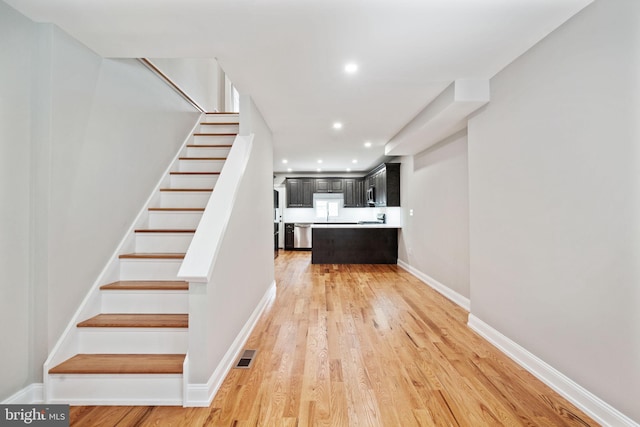 stairs with wood-type flooring