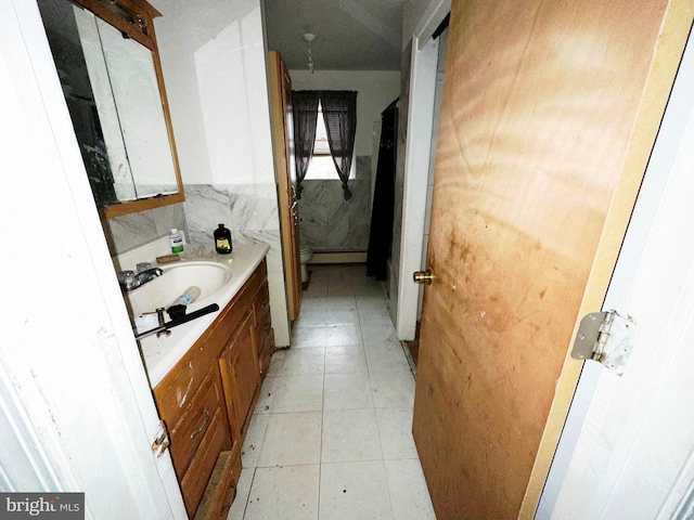 bathroom featuring vanity, tile patterned floors, and a baseboard heating unit