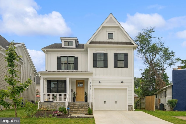 view of front of home with covered porch and a garage