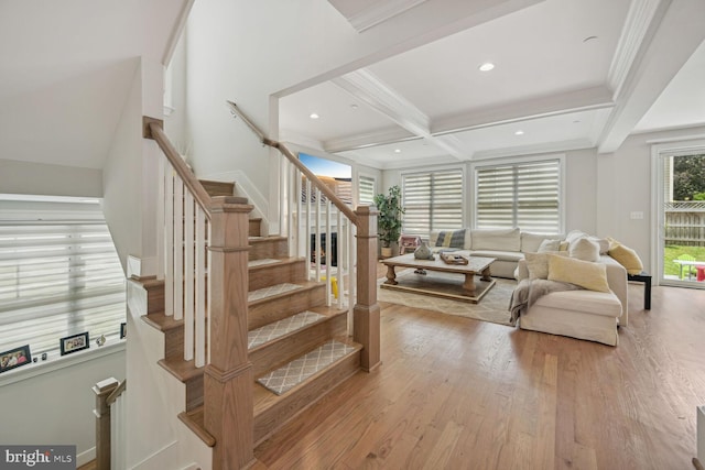 living room with beam ceiling, light hardwood / wood-style floors, ornamental molding, and coffered ceiling