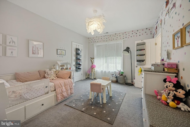 bedroom featuring carpet floors and an inviting chandelier